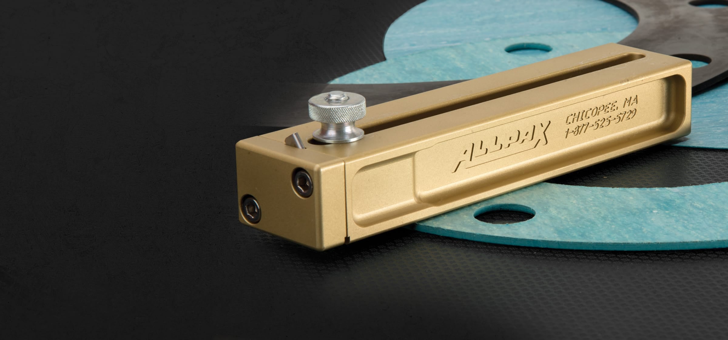 A close-up of a brass cutter block placed on top of circular gaskets.